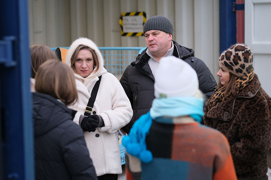 Besökare på Mosseruds återvinningscentral står och samtalar tillsammans.