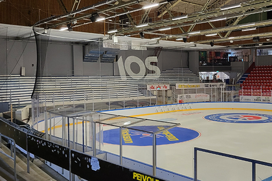En ishall med läktare i bakgrunden.