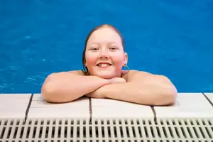 Ett tennisrack i närbild. Framför ligger en tennnisboll. 